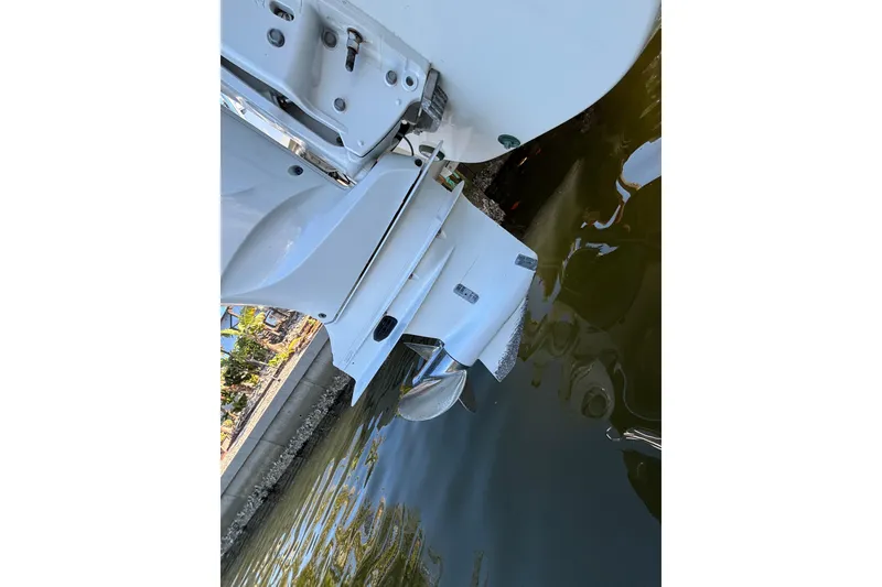 Slide: The Image of 2023 World Cat 295 CC boat engine in water, showcasing propeller and hull design. - 25