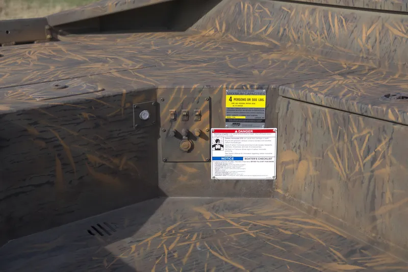 Slide: The Image of 2026 G3 Gator Tough 17 DK boat interior with camouflage design and safety labels. - 10