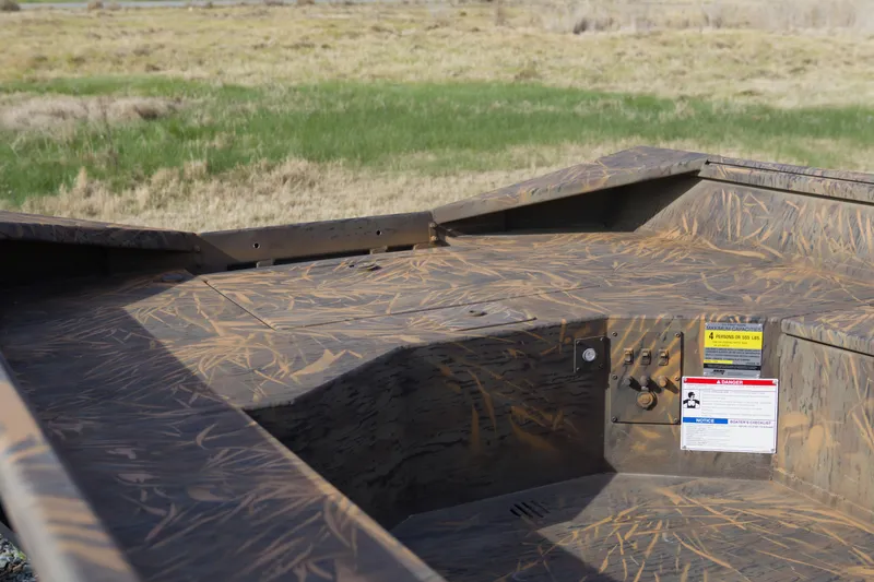 Slide: The Image of 2026 G3 Gator Tough 17 DK boat with camouflage pattern in grassy landscape. - 11