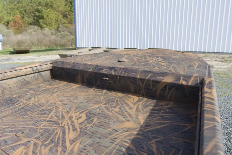 Slide: The Image of Camouflage-patterned deck of 2026 G3 Gator Tough 17 DK boat outdoors. - 12