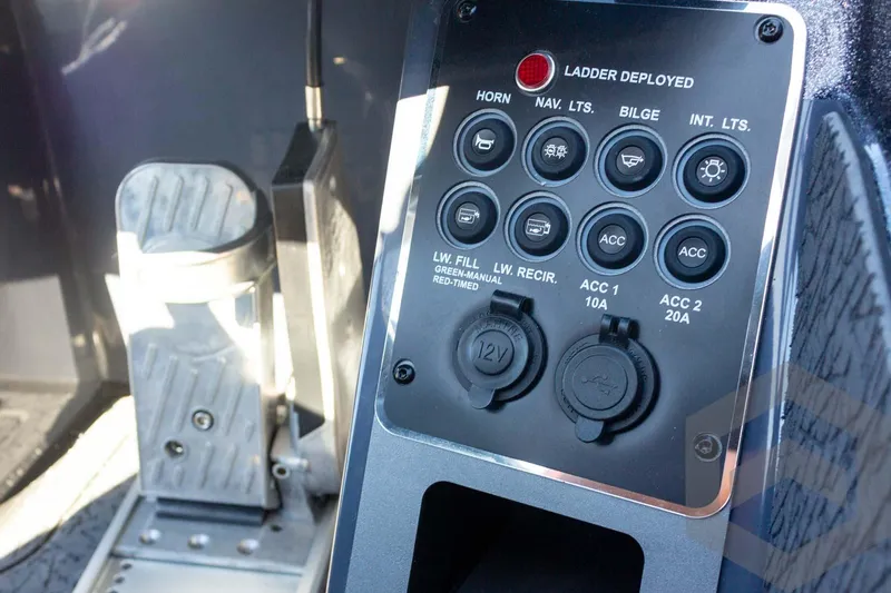 Slide: The Image of Control panel of 2026 Vexus VXs21 boat with various switches and foot pedal. - 27