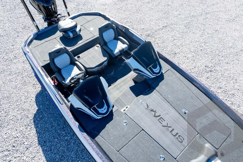 Slide: The Image of 2026 Vexus VXs21 boat interior with dual seats and sleek design on gravel surface. - 47