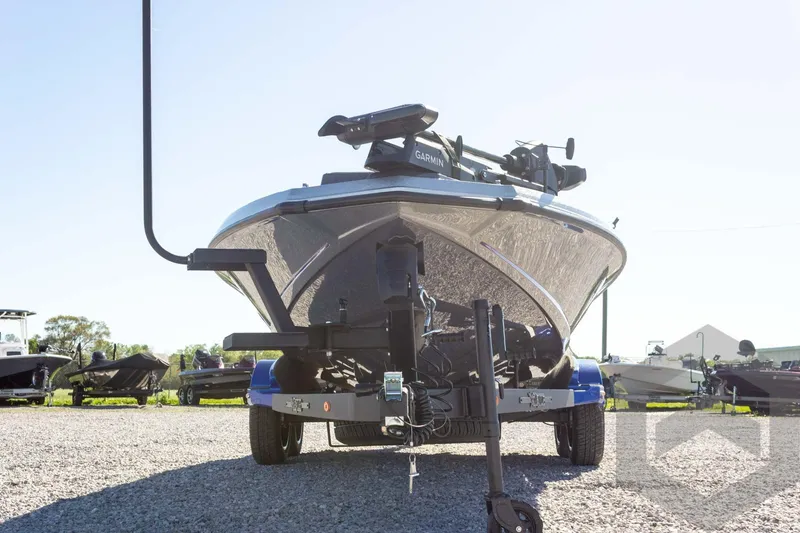 Slide: The Image of 2026 Vexus VXs21 boat on trailer, featuring Garmin equipment, parked outdoors. - 7