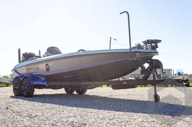 Slide: The Image of 2026 Vexus VXs21 boat on trailer, parked on gravel under clear sky. - 8