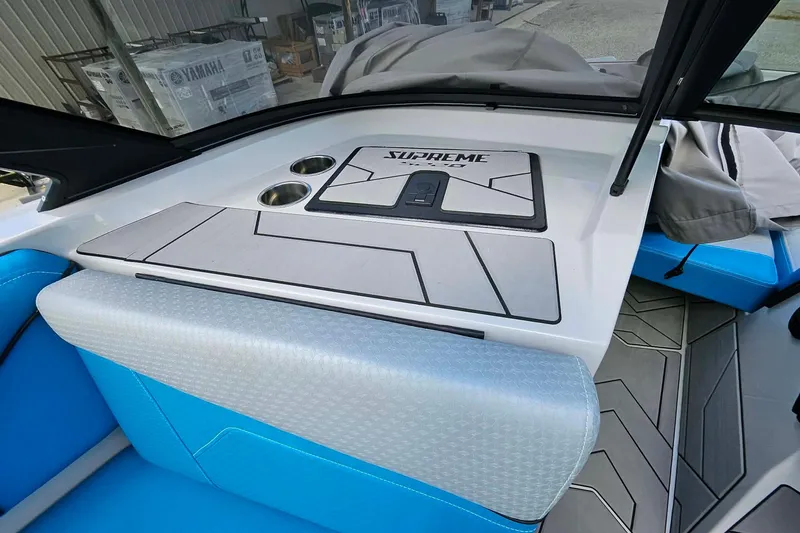 Slide: The Image of Interior of 2022 Supreme S220 boat with blue seating and modern design. - 12
