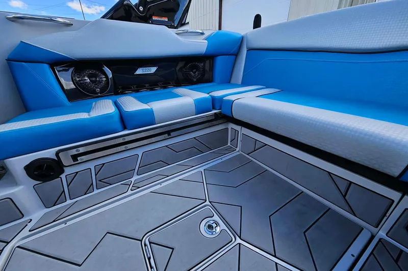 Slide: The Image of Interior of 2022 Supreme S220 boat with blue seating and modern flooring design. - 18