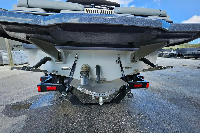 Slide: The Image of Rear view of a 2022 Supreme S220 boat on a trailer, showcasing its hull and components. - 7