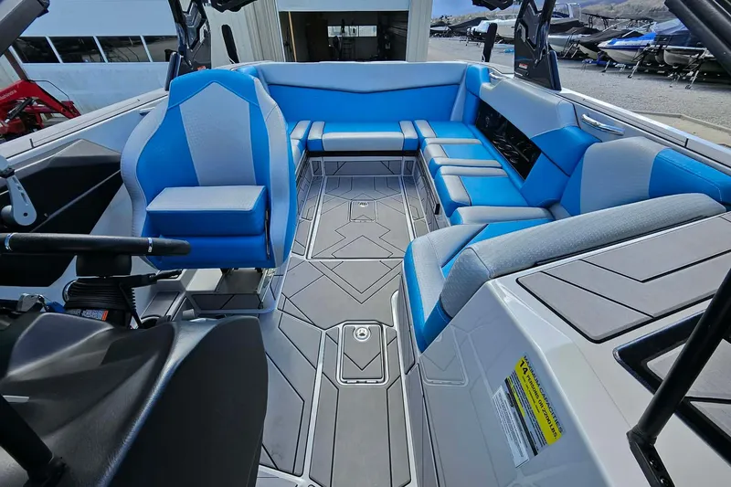 Slide: The Image of 2022 Supreme S220 boat interior with blue seating and modern design. - 9
