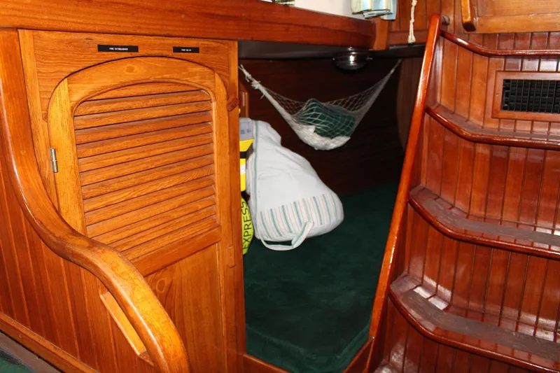 Slide: The Image of Interior of 1990 Slocum 43 sailboat with wooden cabinetry and steps. - 15