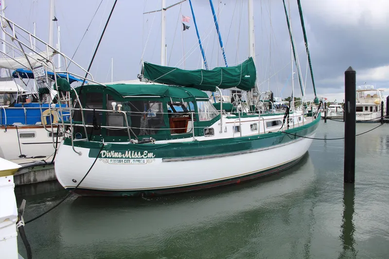 Slide: The Image of Sailboat "Divine Miss Em," Slocum 43, docked in marina, overcast sky. - 2