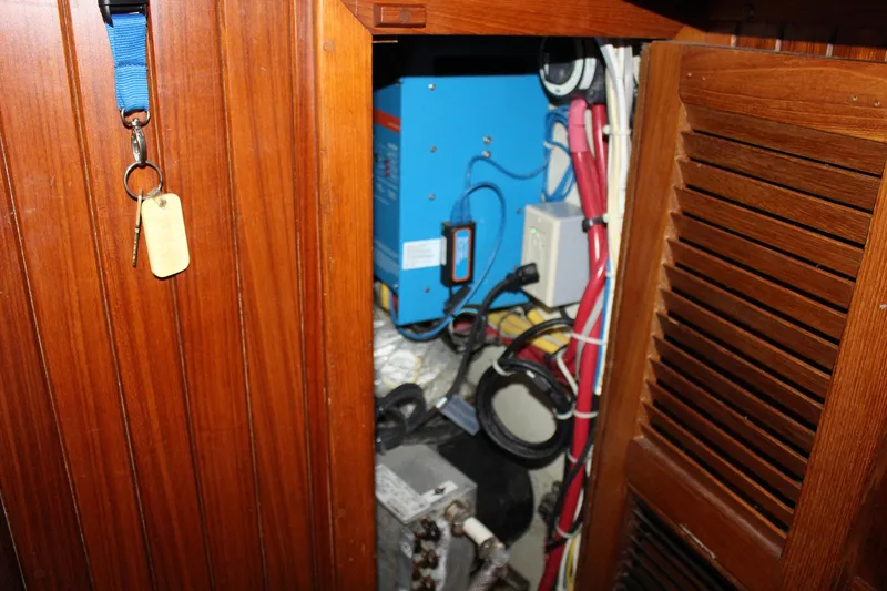 Slide: The Image of Electrical panel inside a 1990 Slocum 43 sailboat with wooden cabinetry. - 25