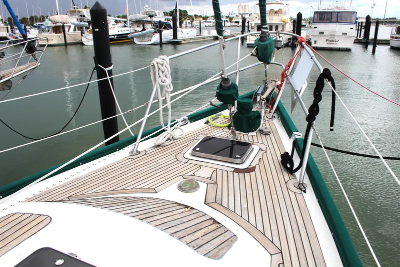 Slide: The Image of Deck view of a 1990 Slocum 43 sailboat docked in a marina. - 5