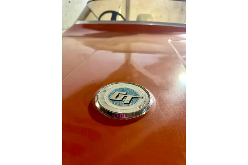 Slide: The Image of 1971 Glastron/Carlson GT 15 boat emblem on orange surface, close-up view. - 17