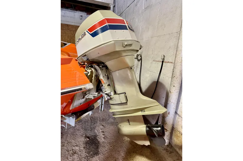 Slide: The Image of 1971 Glastron/Carlson GT 15 boat with Evinrude outboard motor in a garage. - 22