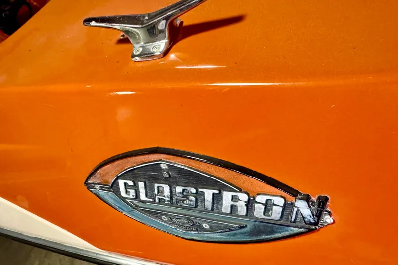 Slide: The Image of 1971 Glastron/Carlson GT 15 boat emblem on vibrant orange surface. - 24