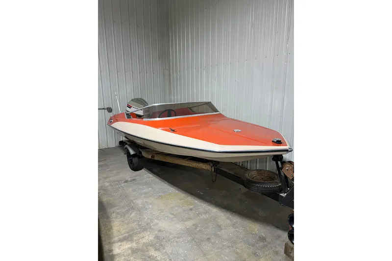 Slide: The Image of 1971 Glastron/Carlson GT 15 boat with orange and white design in a storage area. - 8