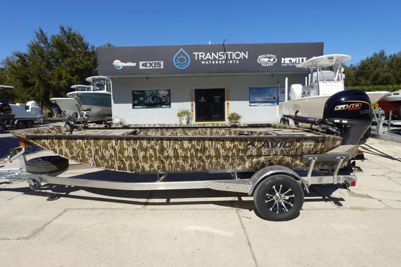 The Image of 2026 Avid 18 Commander boat with camouflage design on a trailer at Transition Watersports. - 1