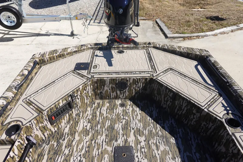 Slide: The Image of 2026 Avid 18 Commander boat interior with camouflage design and storage compartments. - 10