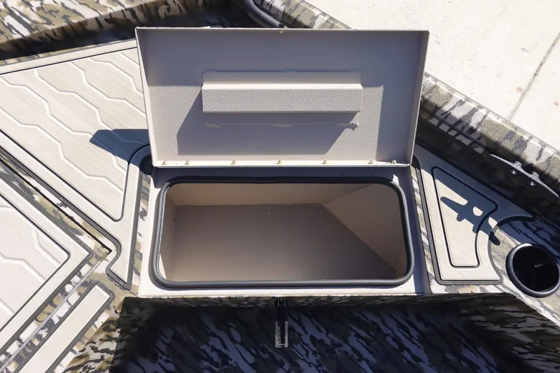 Slide: The Image of Open storage compartment on 2026 Avid 18 Commander boat deck. - 13