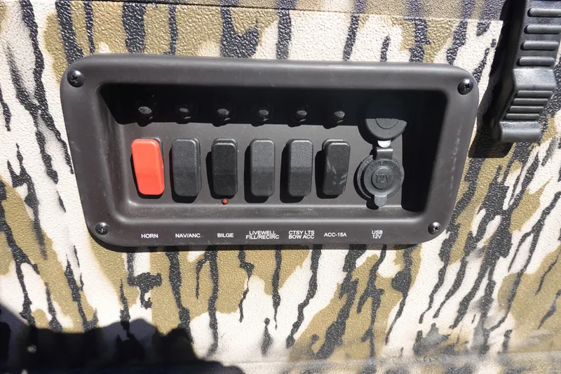 Slide: The Image of Control panel of 2026 Avid 18 Commander boat with switches and USB port. - 14