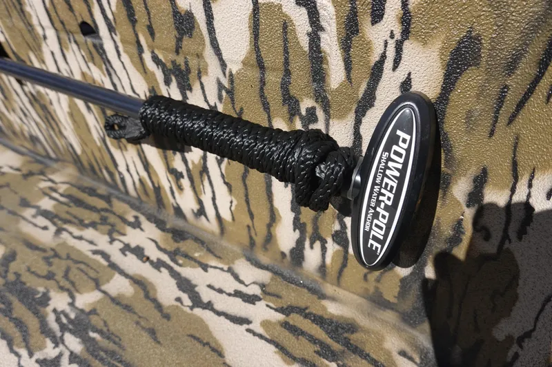 Slide: The Image of Close-up of Power-Pole anchor on 2026 Avid 18 Commander boat with camouflage pattern. - 16