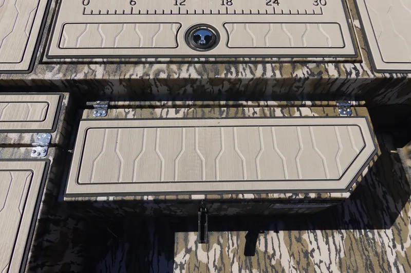 Slide: The Image of 2026 Avid 18 Commander boat deck with camouflage pattern and storage compartments. - 19