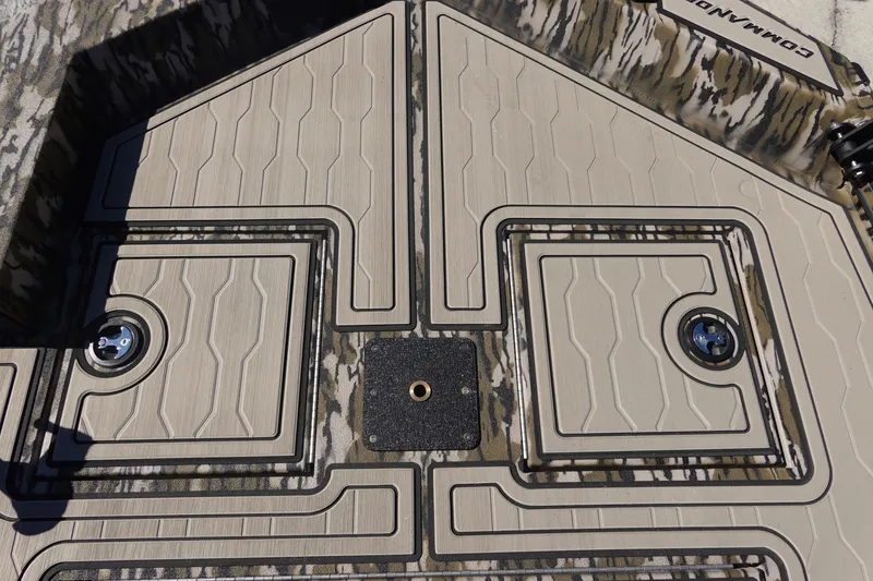 Slide: The Image of 2026 Avid 18 Commander boat deck with camo pattern and storage compartments. - 23