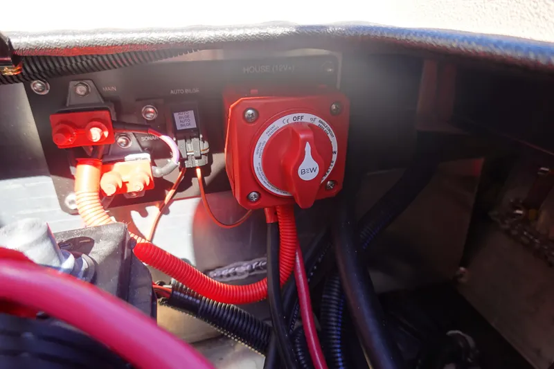 Slide: The Image of Electrical panel of 2026 Avid 18 Commander boat with red wiring and switches. - 28