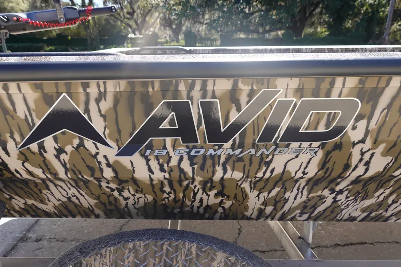 Slide: The Image of 2026 Avid 18 Commander boat with camouflage design and logo. - 5