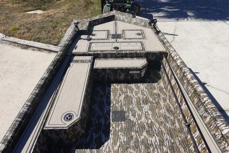 Slide: The Image of 2026 Avid 18 Commander boat interior with camouflage design and storage compartments. - 9