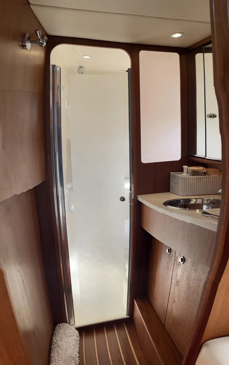 Slide: The Image of 2008 Tiara Yachts 3500 Sovran bathroom with wooden cabinetry and modern shower. - 14