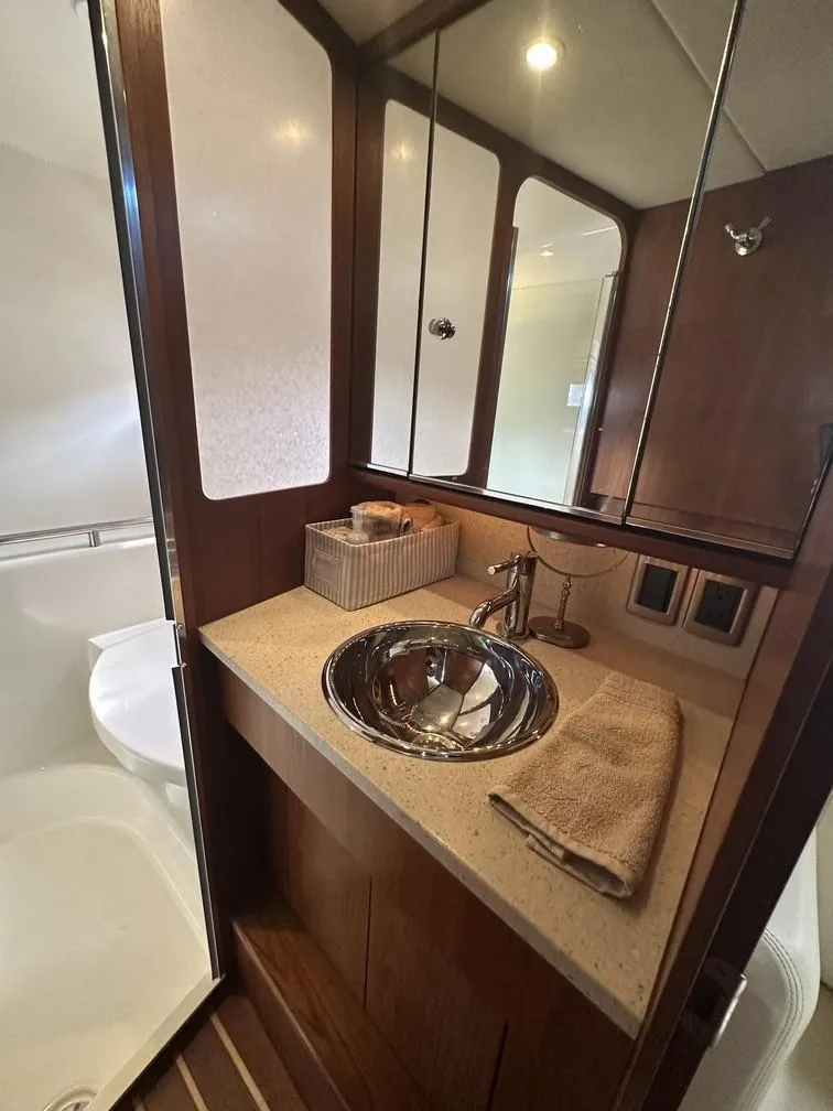 Slide: The Image of 2008 Tiara Yachts 3500 Sovran bathroom with sleek sink and wooden cabinetry. - 16