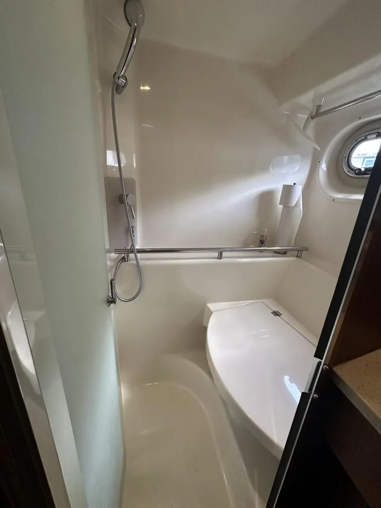 Slide: The Image of 2008 Tiara Yachts 3500 Sovran bathroom with shower and porthole window. - 17