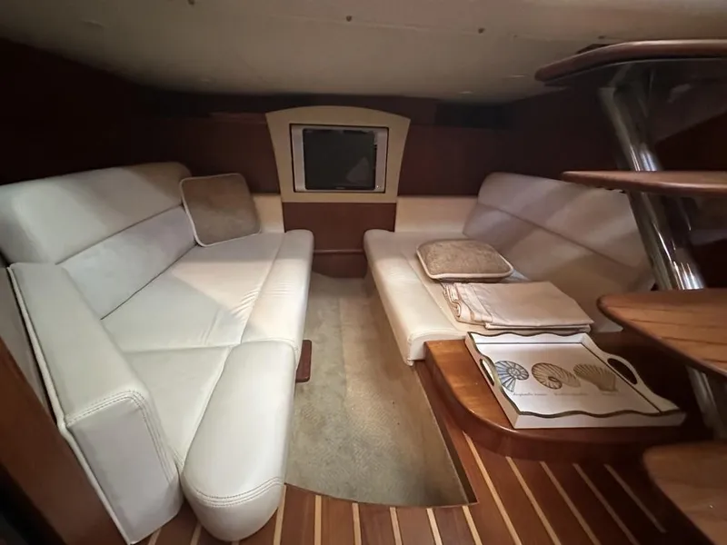 Slide: The Image of 2008 Tiara Yachts 3500 Sovran interior with white seating and wooden flooring. - 19