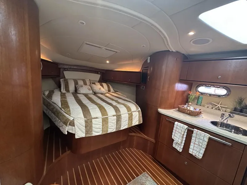 Slide: The Image of Luxurious interior of 2008 Tiara Yachts 3500 Sovran with cozy bed and kitchenette. - 20
