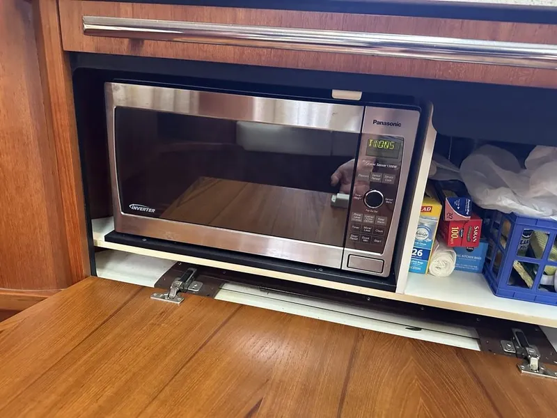 Slide: The Image of Microwave in 2008 Tiara Yachts 3500 Sovran kitchen with wooden cabinetry. - 25