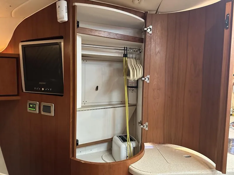 Slide: The Image of 2008 Tiara Yachts 3500 Sovran interior with open wooden cabinet and TV. - 27