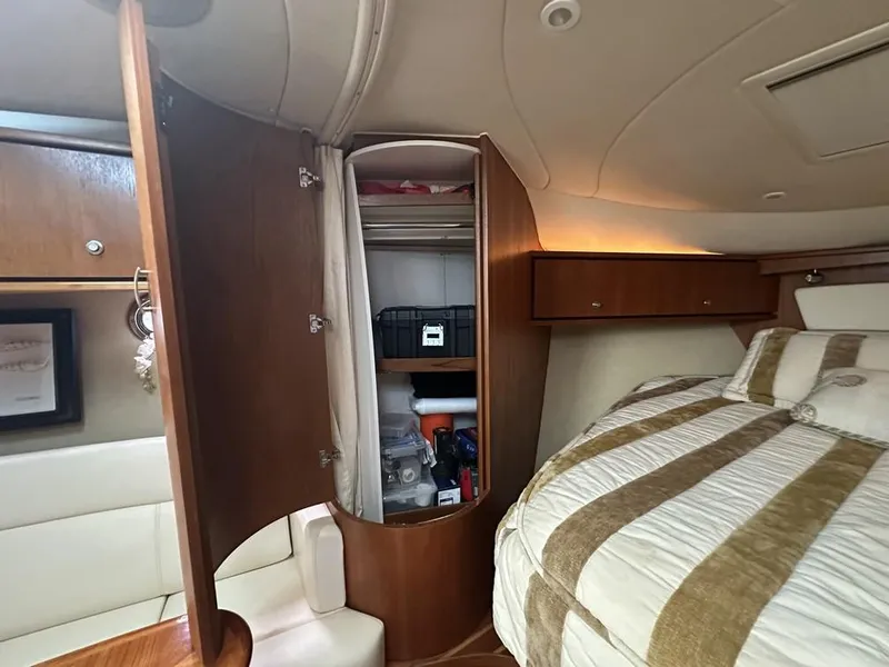 Slide: The Image of 2008 Tiara Yachts 3500 Sovran cabin interior with open closet and bed. - 28