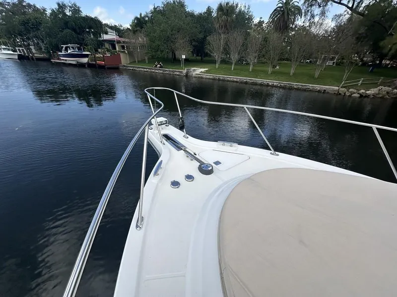 Slide: The Image of 2008 Tiara Yachts 3500 Sovran on calm water near a lush shoreline. - 36