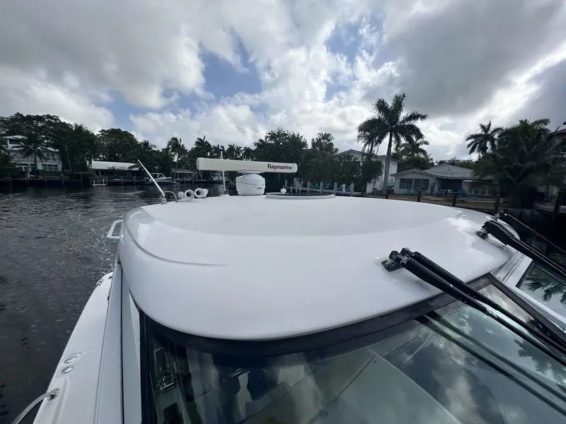 Slide: The Image of 2008 Tiara Yachts 3500 Sovran on a calm waterway with palm trees in the background. - 41