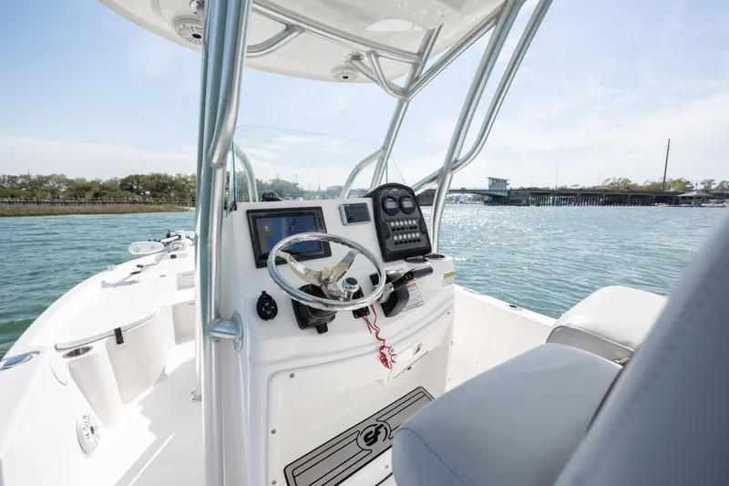 Slide: The Image of 2019 Sea Fox 220 Viper boat console with steering wheel and controls on open water. - 13
