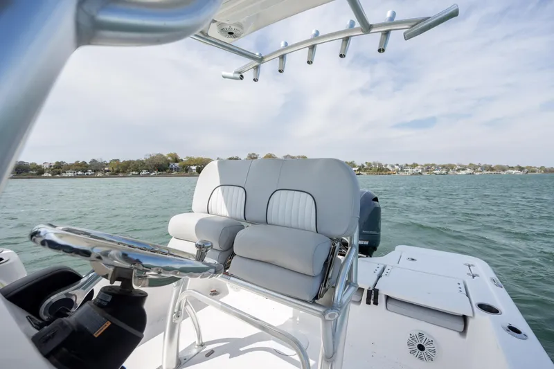 Slide: The Image of 2019 Sea Fox 220 Viper boat interior with steering wheel and seating on open water. - 15