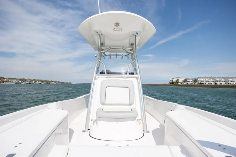 Slide: The Image of 2019 Sea Fox 220 Viper boat on water, clear sky, coastal buildings in background. - 20
