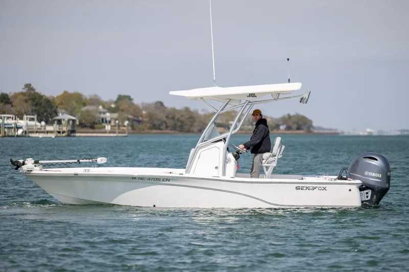 Slide: The Image of 2019 Sea Fox 220 Viper boat cruising on a calm lake with a Yamaha engine. - 4