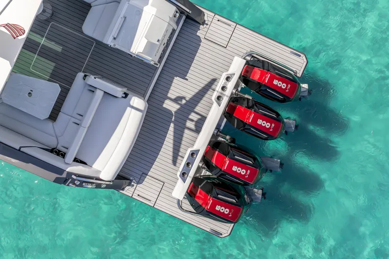Slide: The Image of Aerial view of 2022 Formula 500 Super Sport Crossover boat with four engines on turquoise water. - 12