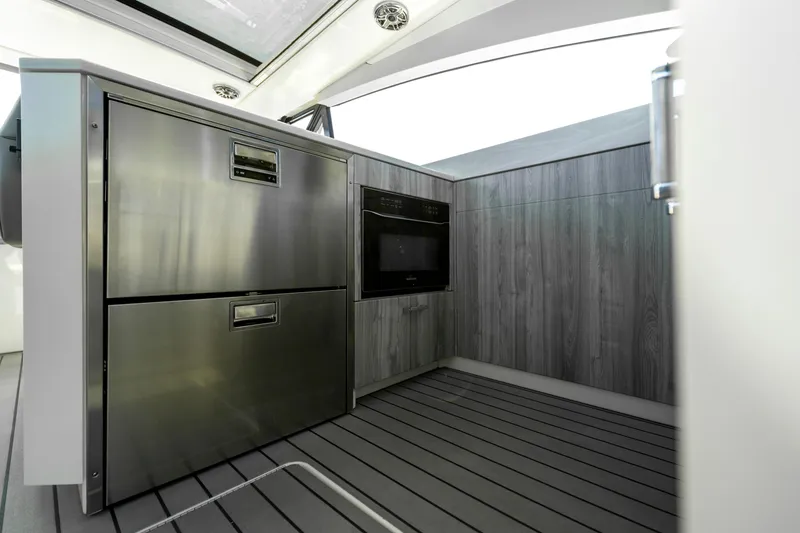 Slide: The Image of Modern kitchen area in 2022 Formula 500 Super Sport Crossover yacht, featuring stainless steel appliances. - 23