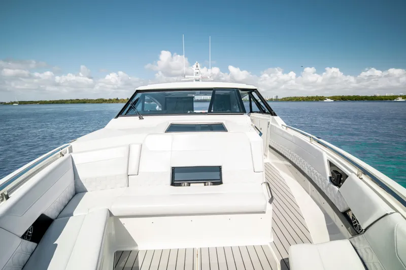 Slide: The Image of 2022 Formula 500 Super Sport Crossover boat on calm water, featuring sleek white seating. - 28