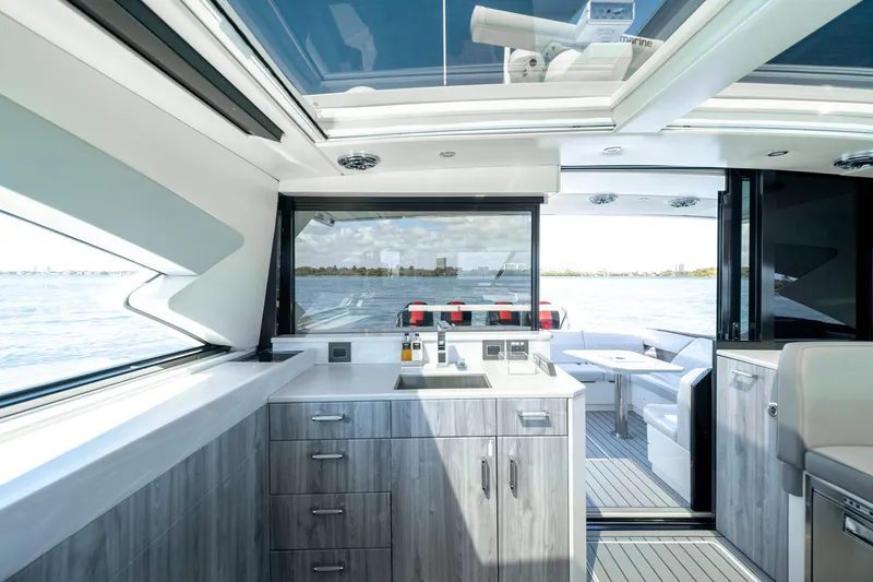 Slide: The Image of Interior of 2022 Formula 500 Super Sport Crossover yacht with modern kitchen and seating area. - 37