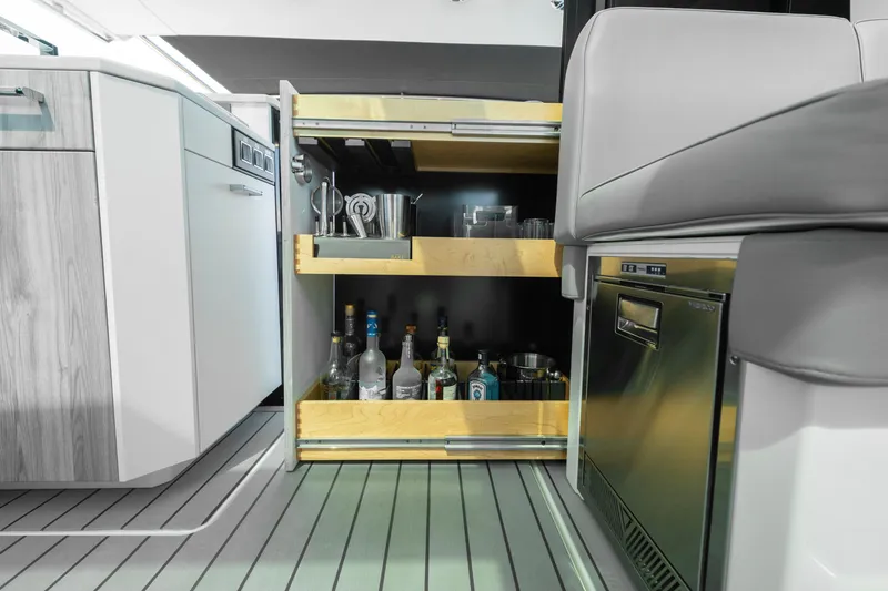 Slide: The Image of 2022 Formula 500 Super Sport Crossover interior with open bar cabinet and modern kitchen amenities. - 46