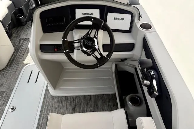 Slide: The Image of 2026 Avalon LSZ Quad Lounge Shift boat dashboard with steering wheel and Simrad displays. - 15